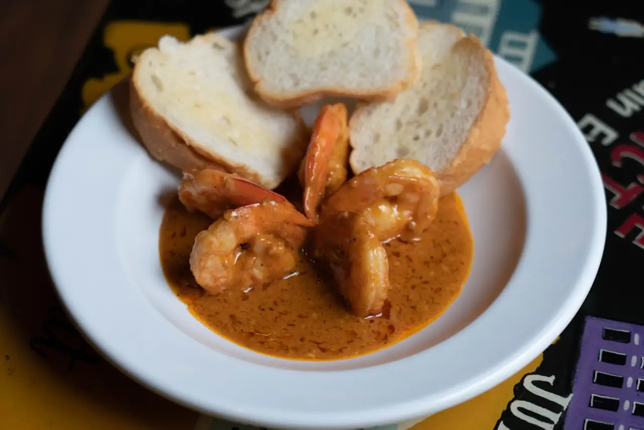 New Orleans barbecued shrimp in a peppery butter sauce with toasted French bread