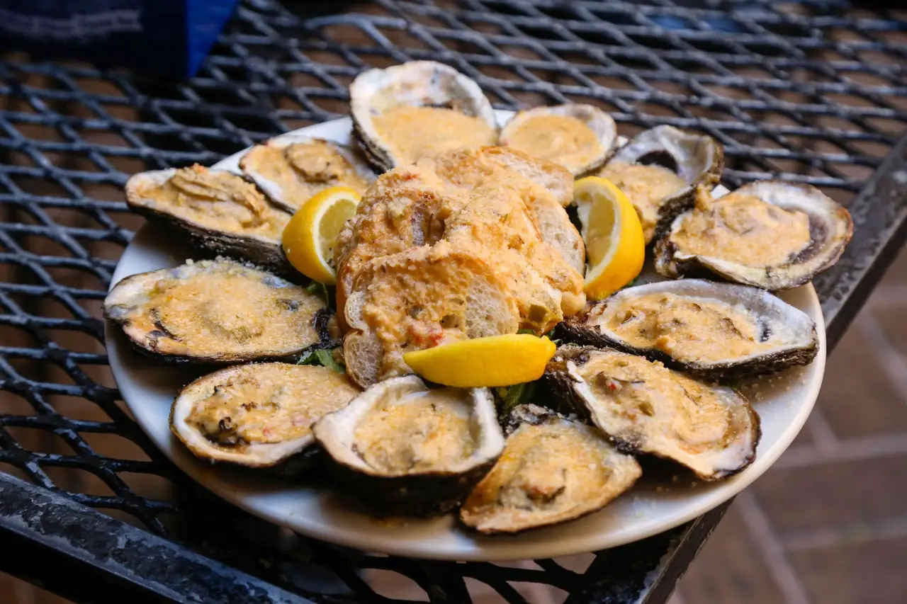 A platter of chargrilled oysters with parmesan, garlic butter and lemon