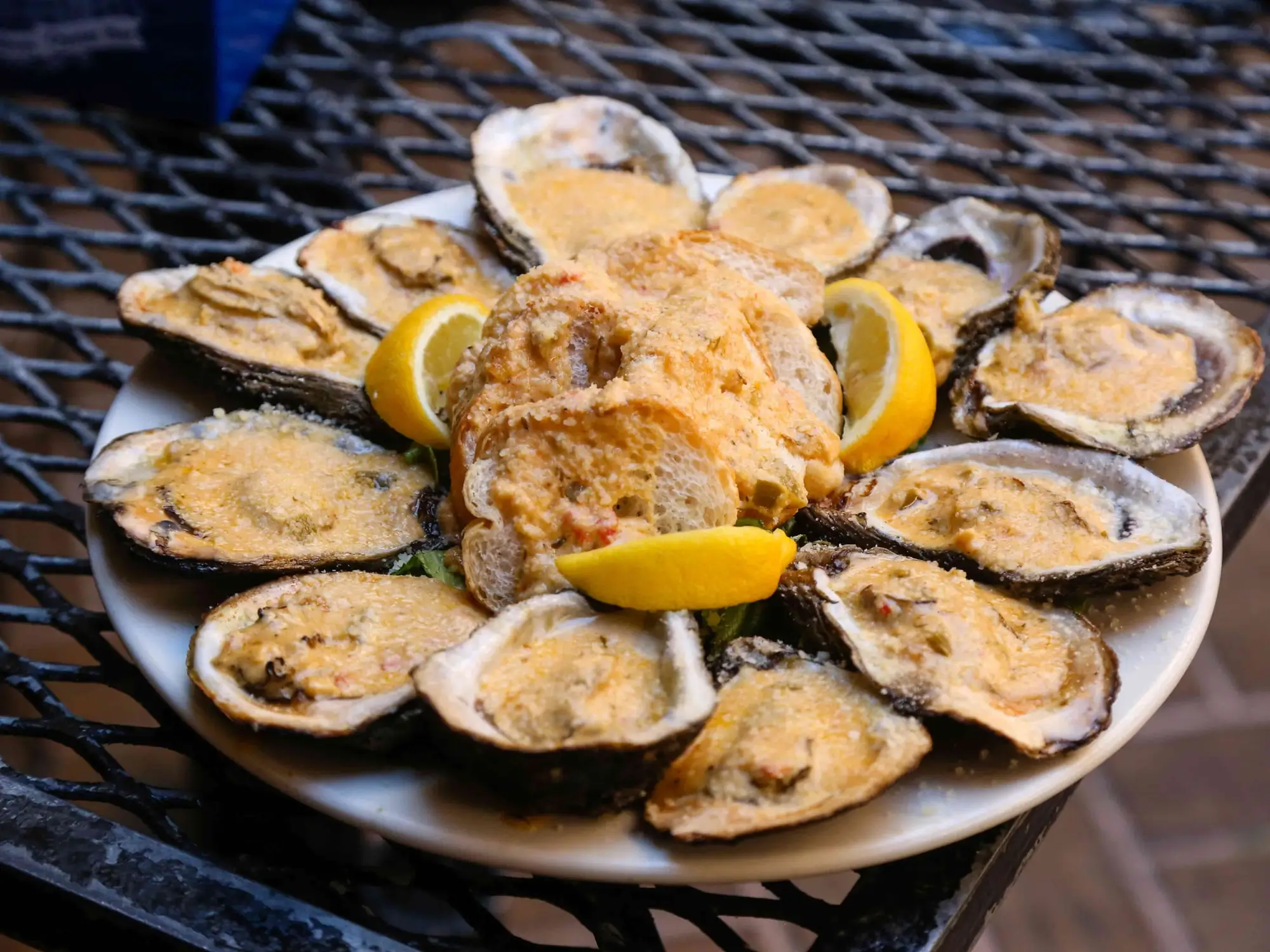 A platter of chargrilled oysters with parmesan, garlic butter and lemon