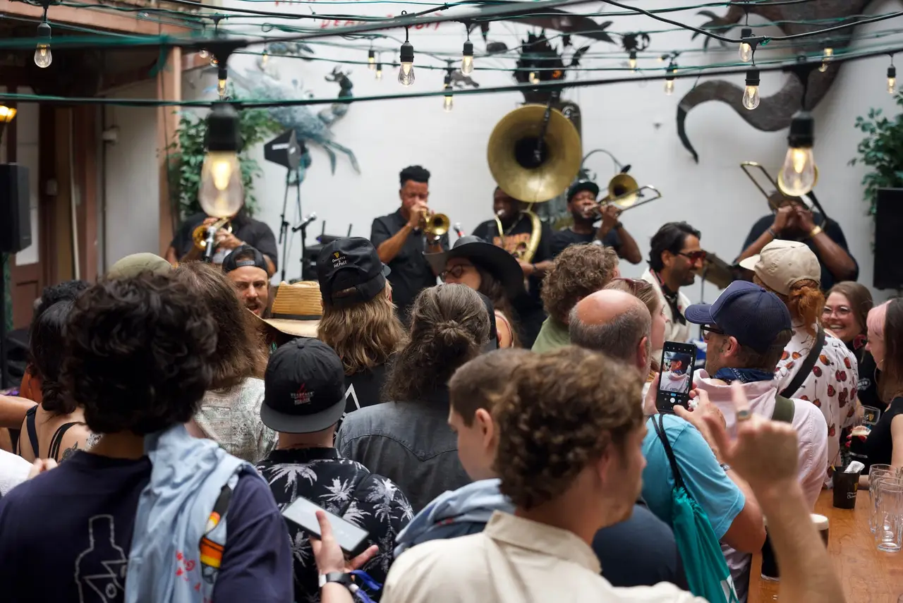 A brass band playing to a packed crowd in Oceana Grill’s courtyard during a private event