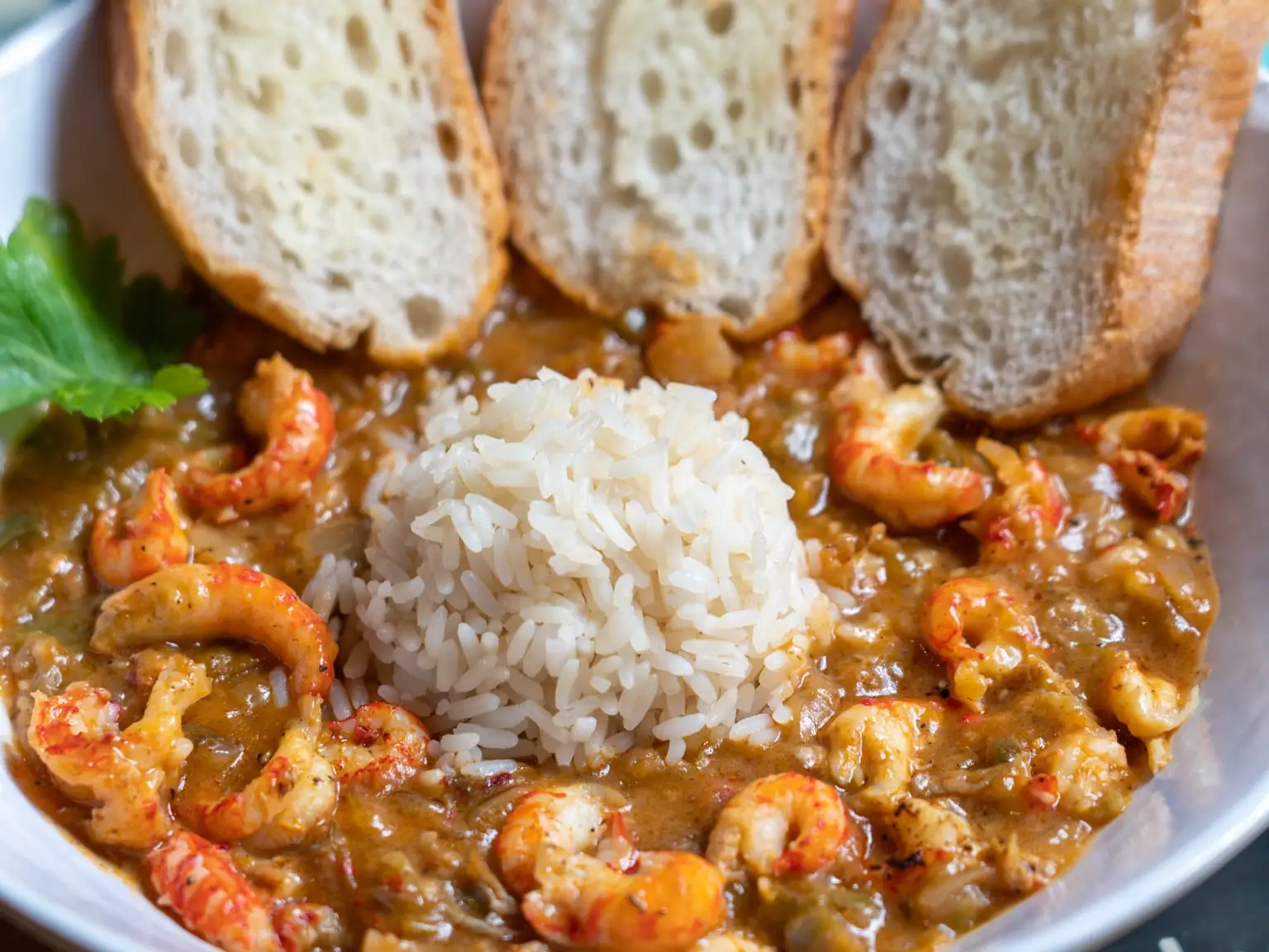 Crawfish étouffée over white rice with toasted French bread