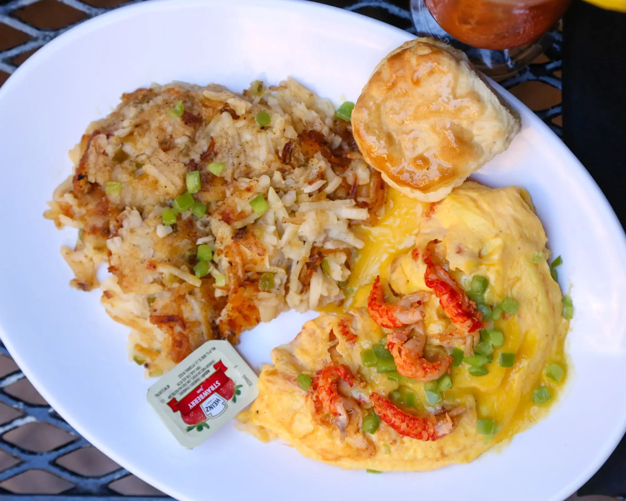 Crawfish omelette topped with hollandaise, with hash browns and a biscuit