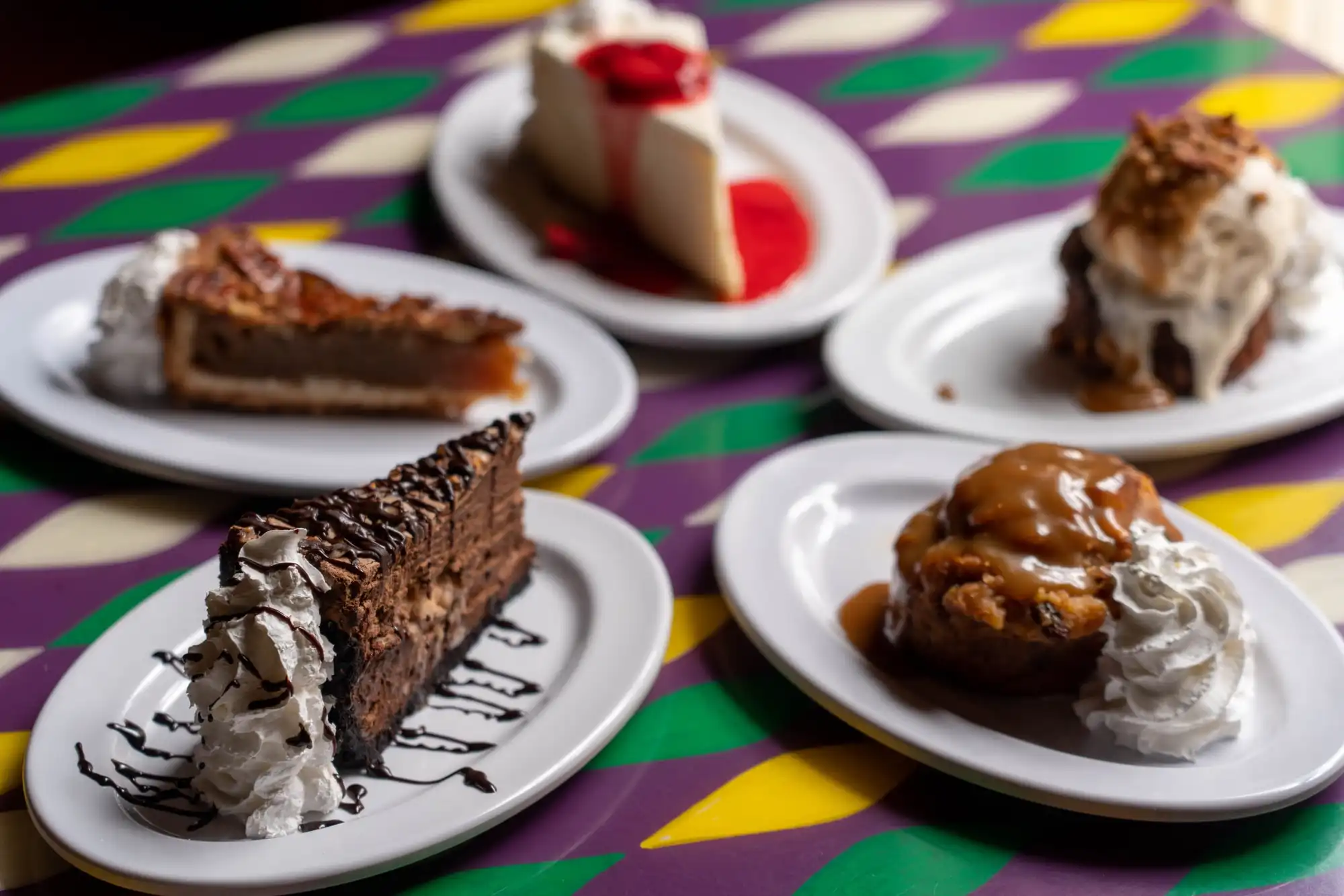 Five desserts from above: cheesecake, bread pudding, pecan pie, chocolate mousse and a crepe