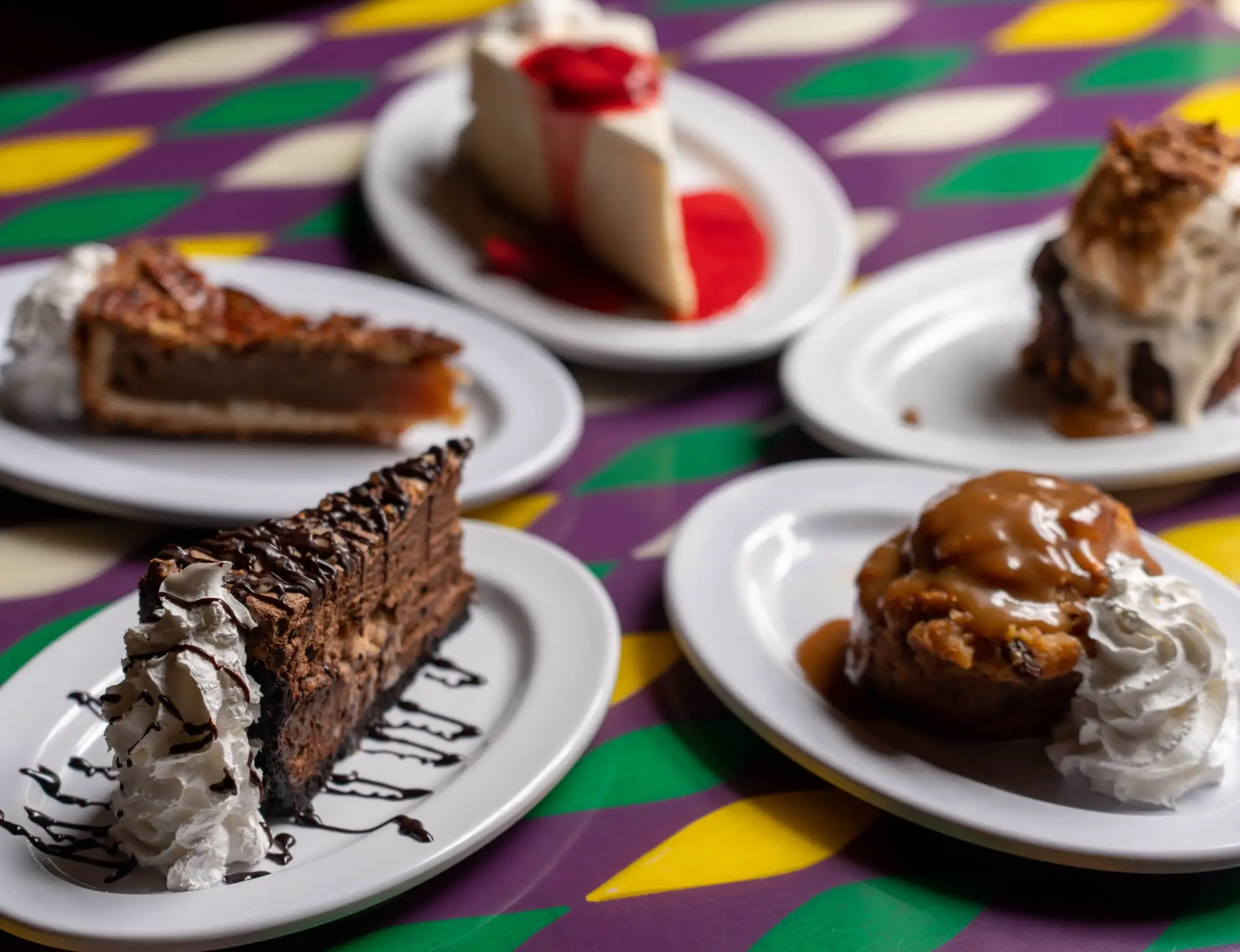 Five desserts from above: cheesecake, bread pudding, pecan pie, chocolate mousse and a crepe