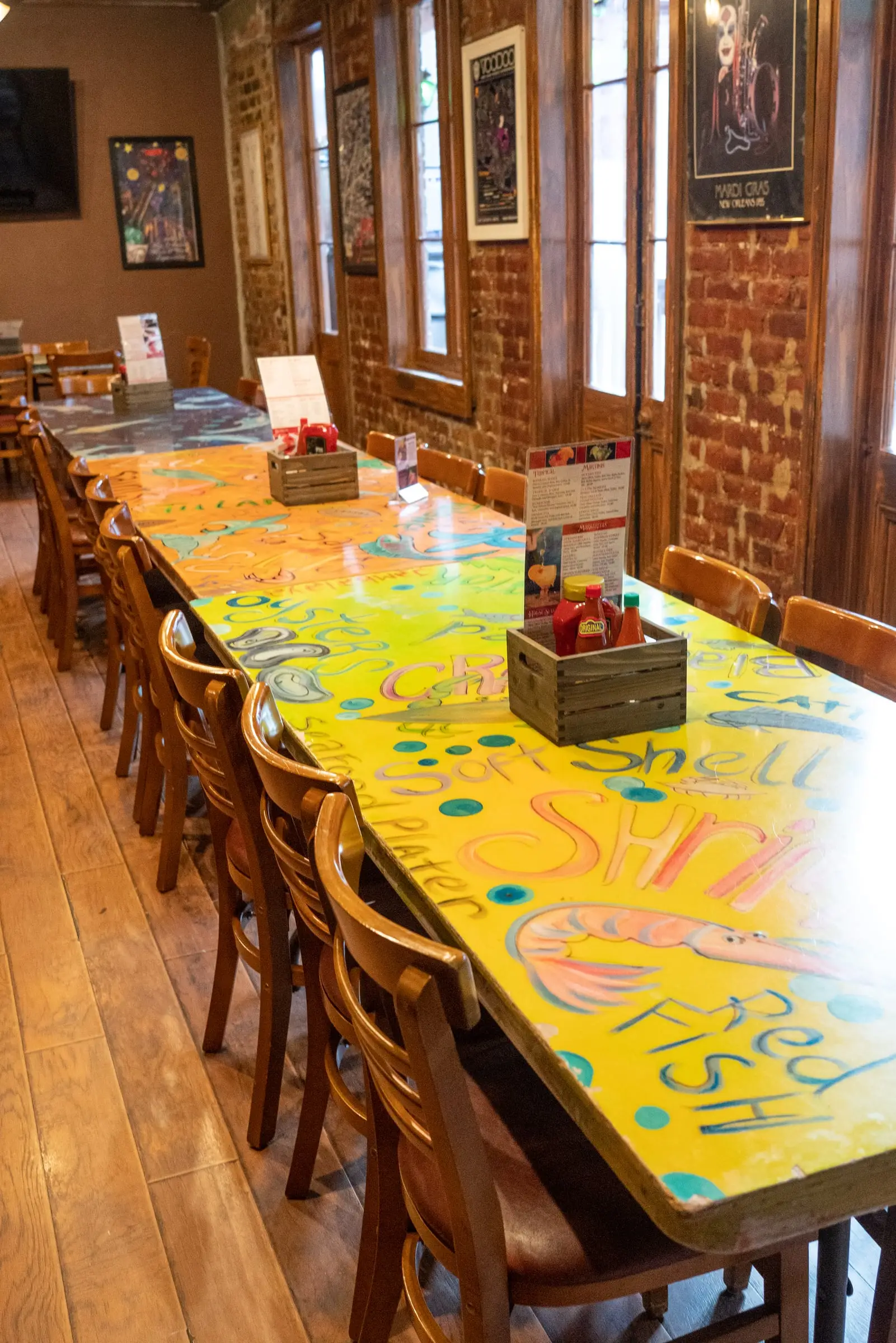 The long, colorfully painted table of the LaFourche Room