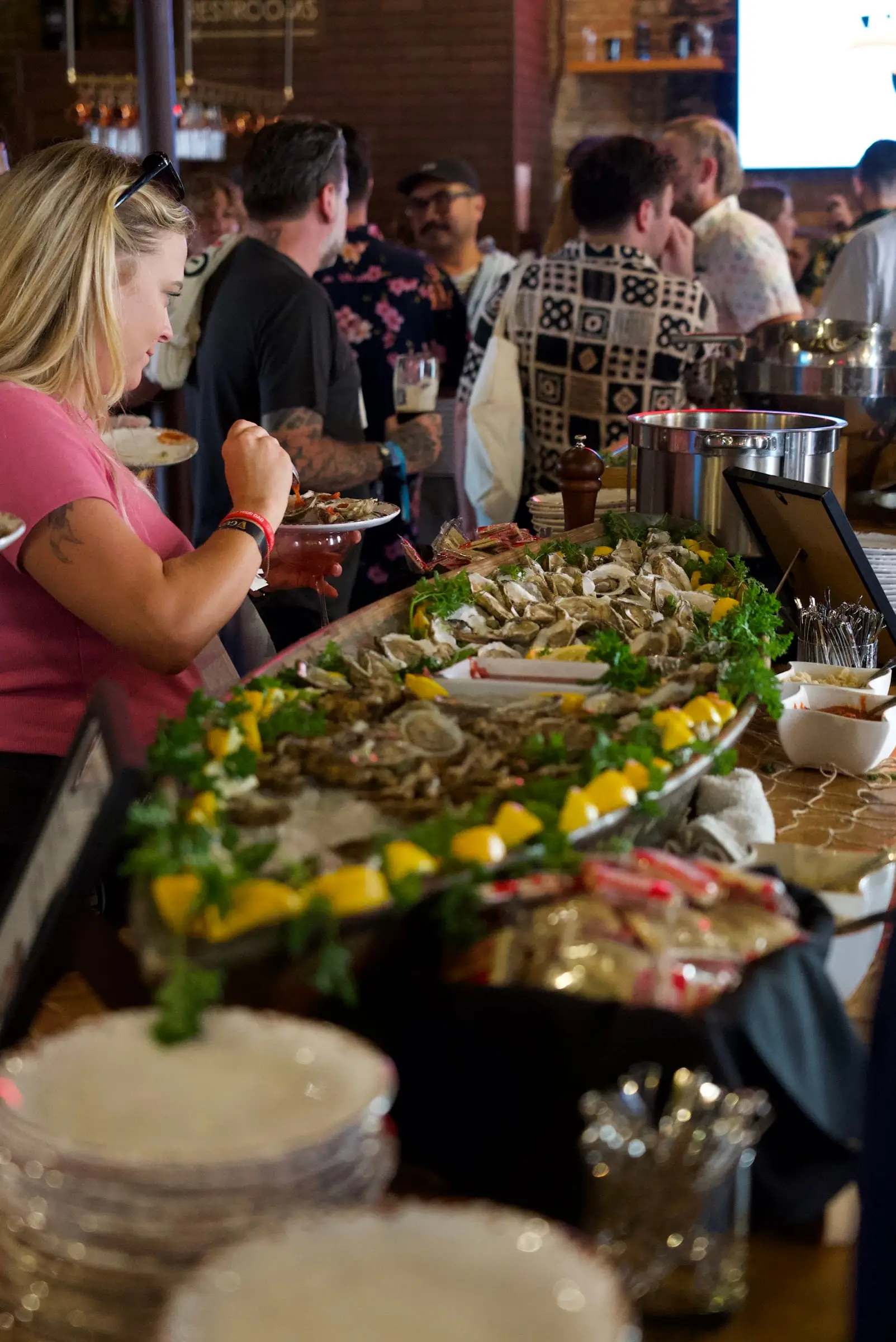 Guests gathered around a raw oyster station on ice at an Oceana event