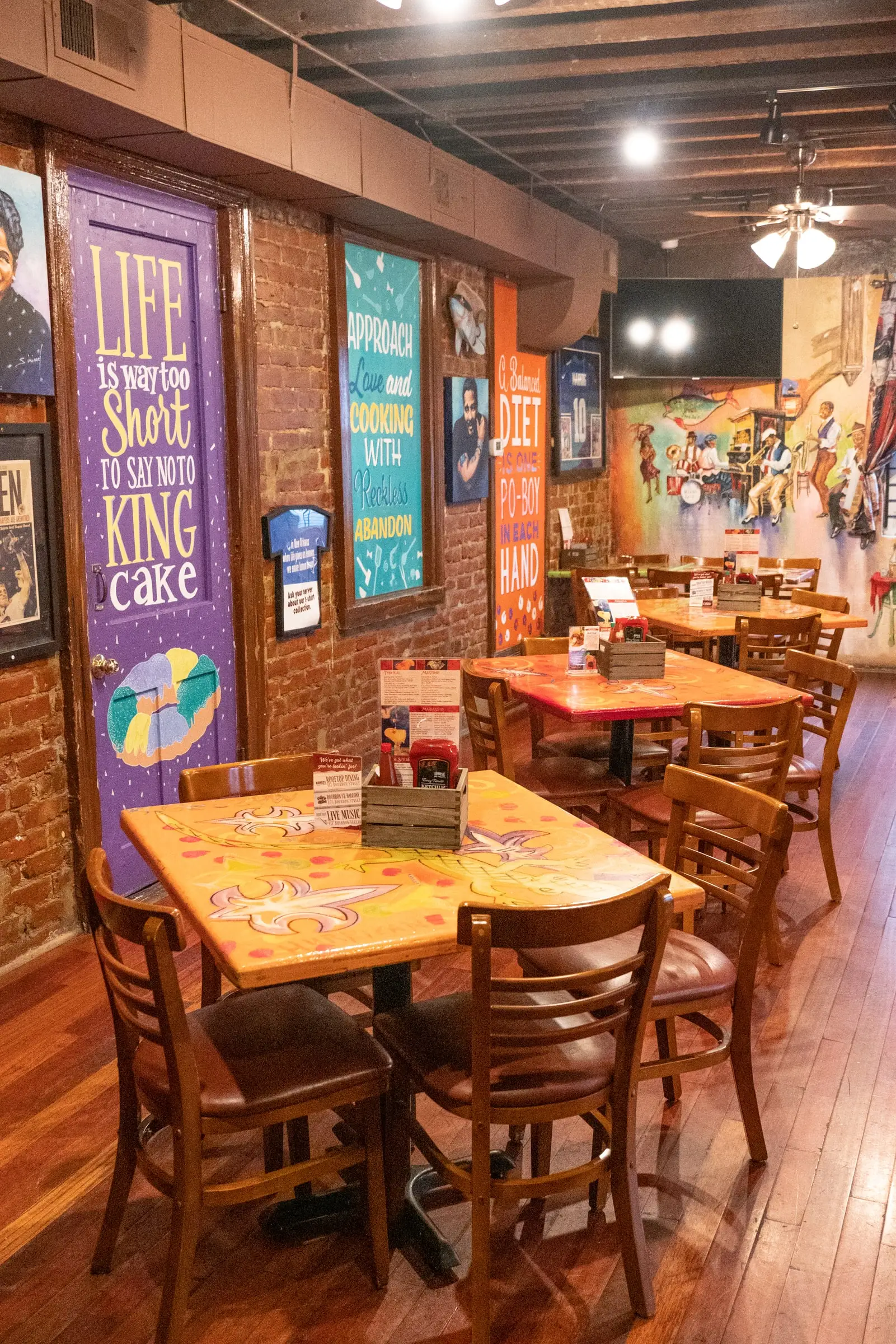 “Life is way too short to say no to king cake” and other hand-painted signs in the Tchoupitoulas Room