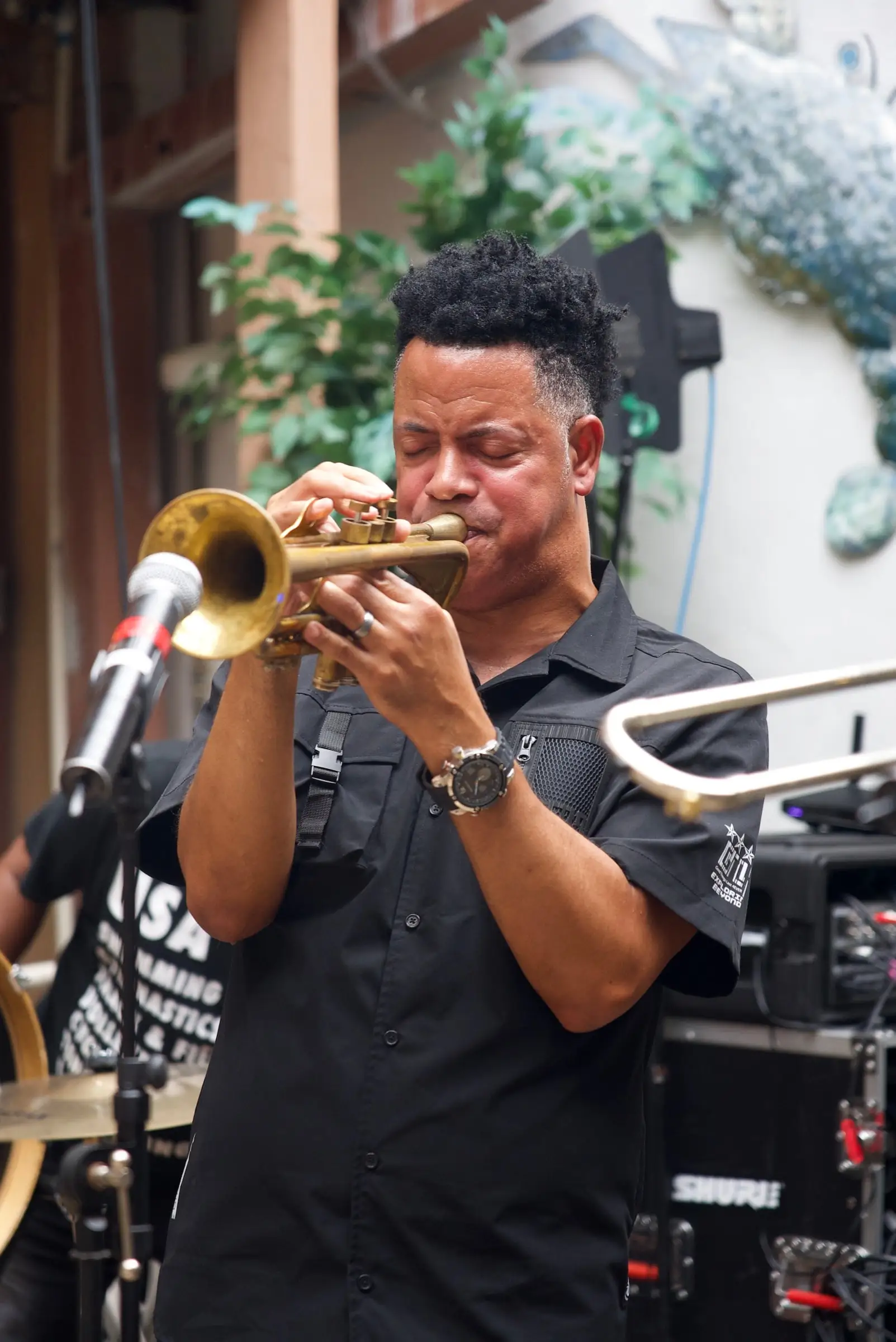 A trumpet player performing at an event in Oceana’s courtyard